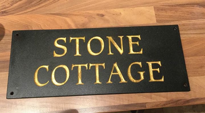 Gold leaf applied to a slate house name for a local house in northwales. North Wales, North West, Wirral, Liverpool & Cheshire UK